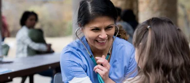 Pediatric cardiologist examining young patient with stethoscope