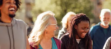Diverse group of adults gathered outdoors in a community setting