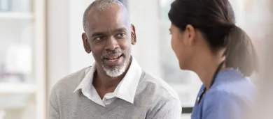Female doctor talking to male patient