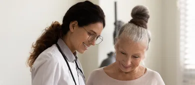 Female doctor talking to elderly female patient