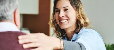 Female doctor embracing male patient